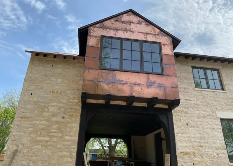 Copper metal panel facade on a stone building for Metal Roof Coating in Weslaco